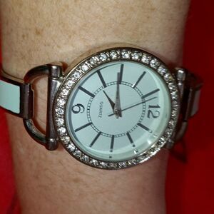 Silver and sea green colored fashion watch
